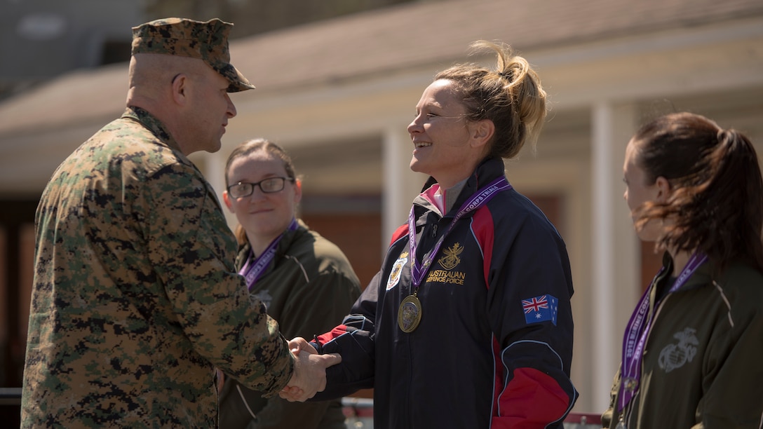 Australian athlete Maj. Kelliegh Jackson shakes hands with U.S. Marine Corps Sgt. Maj. Karl Simburger during the 2018 Marine Corps Trials cycling competition medal ceremony at Marine Corps Base Camp Lejeune, N.C., March 18, 2018. The Marine Corps Trials promotes recovery and rehabilitation through adaptive sport participation and develops camaraderie among recovering service members and veterans. It is an opportunity for RSMs to demonstrate their achievements and serves as the primary venue to select Marine Corps participants for the DoD Warrior Games.
