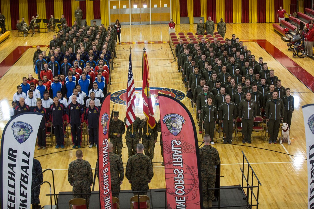 The 2018 Marine Corps Trials athletes stand at attention as colors pass during the opening ceremony on Marine Corps Base Camp Lejeune, N.C., March 17, 2018. The Marine Corps Trials promotes recovery and rehabilitation through adaptive sport participation and develops camaraderie among recovering service members and veterans. It is as an opportunity for RSMs to demonstrate their achievements and serves as the primary venue to select Marine Corps participants for the DoD Warrior Games.