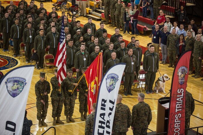The 2018 Marine Corps Trials athletes stand at attention as colors pass during the opening ceremony on Marine Corps Base Camp Lejeune, N.C., March 17, 2018. The Marine Corps Trials promotes recovery and rehabilitation through adaptive sport participation and develops camaraderie among recovering service members and veterans. It is as an opportunity for RSMs to demonstrate their achievements and serves as the primary venue to select Marine Corps participants for the DoD Warrior Games.
