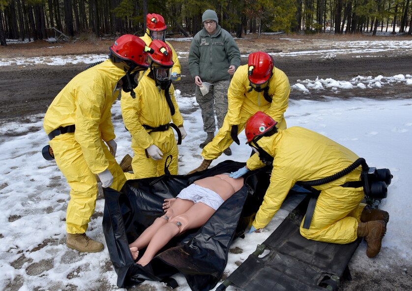 Service members prepare to remove a simulated battlefield casualty during a simulated Chemical, Biological, Radiological, Nuclear and Explosive (CBRNE) attack at Operation Joint Recovery exercise on Joint Base McGuire-Dix-Lakehurst, N.J., Mar. 10, 2018. Additional scenarios included a downed aircraft, a tornado disaster as well as combat search and recovery missions. (U.S. Air Force photo by Tech. Sgt. Robert M. Trujillo)