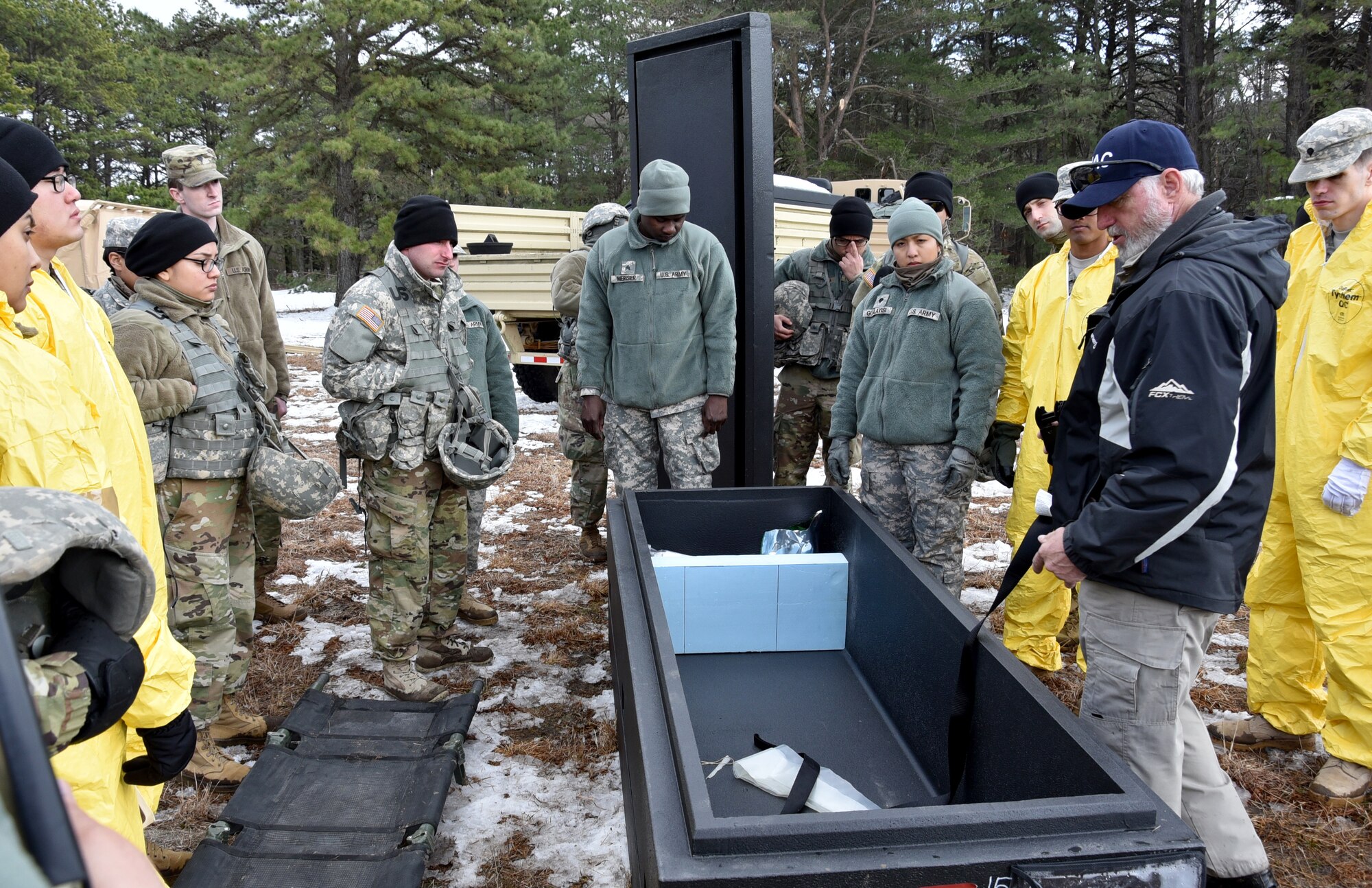 Kenneth Tabor (right), Joint Mortuary Affairs Center mortuary operations specialist, explains the procedures of a transfer case during Operation Joint Recovery exercise at Joint Base McGuire-Dix-Lakehurst, N.J., Mar. 10, 2018. More than 200 active duty and reservists service members from the U.S. Army, Air Force, Navy and Marines. (U.S. Air Force photo by Tech. Sgt. Robert M. Trujillo)