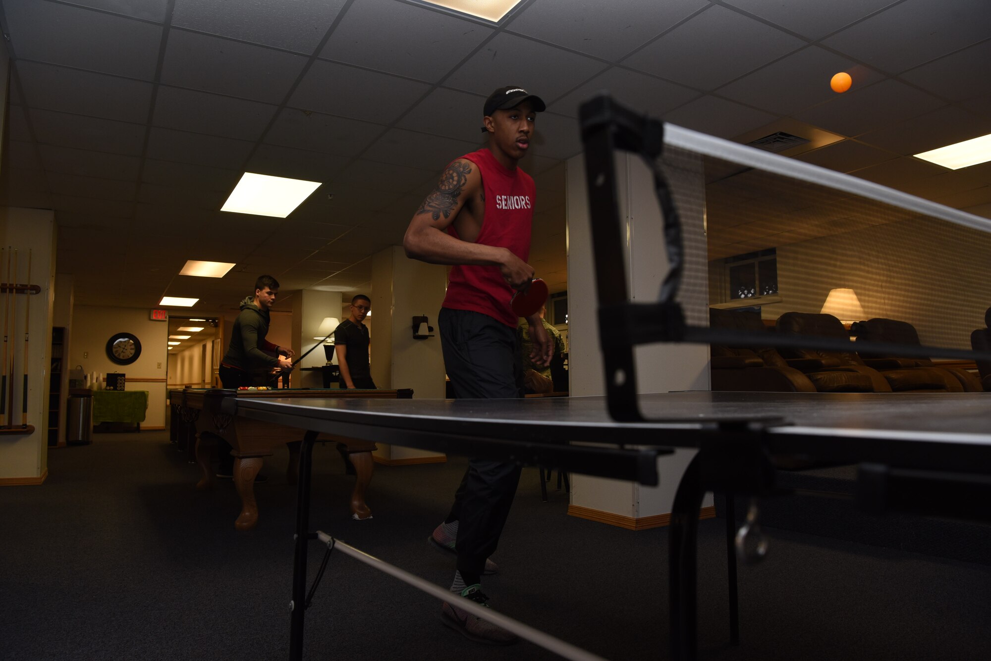 Airmen play various games after enjoying dinner at Higher Grounds, F.E. Warren Air Force Base, Wyoming, March 14, 2018. The space is full of table, video and board games for visitors to play, and on occasion there are tournaments put together. Higher Grounds is a place for Airmen to relax, watch T.V., play video games and connect with other Airmen. There are volunteer opportunities, recreational trips, and fellowship. (U.S. Air Force photos by Airman 1st Class Abbigayle Wagner)