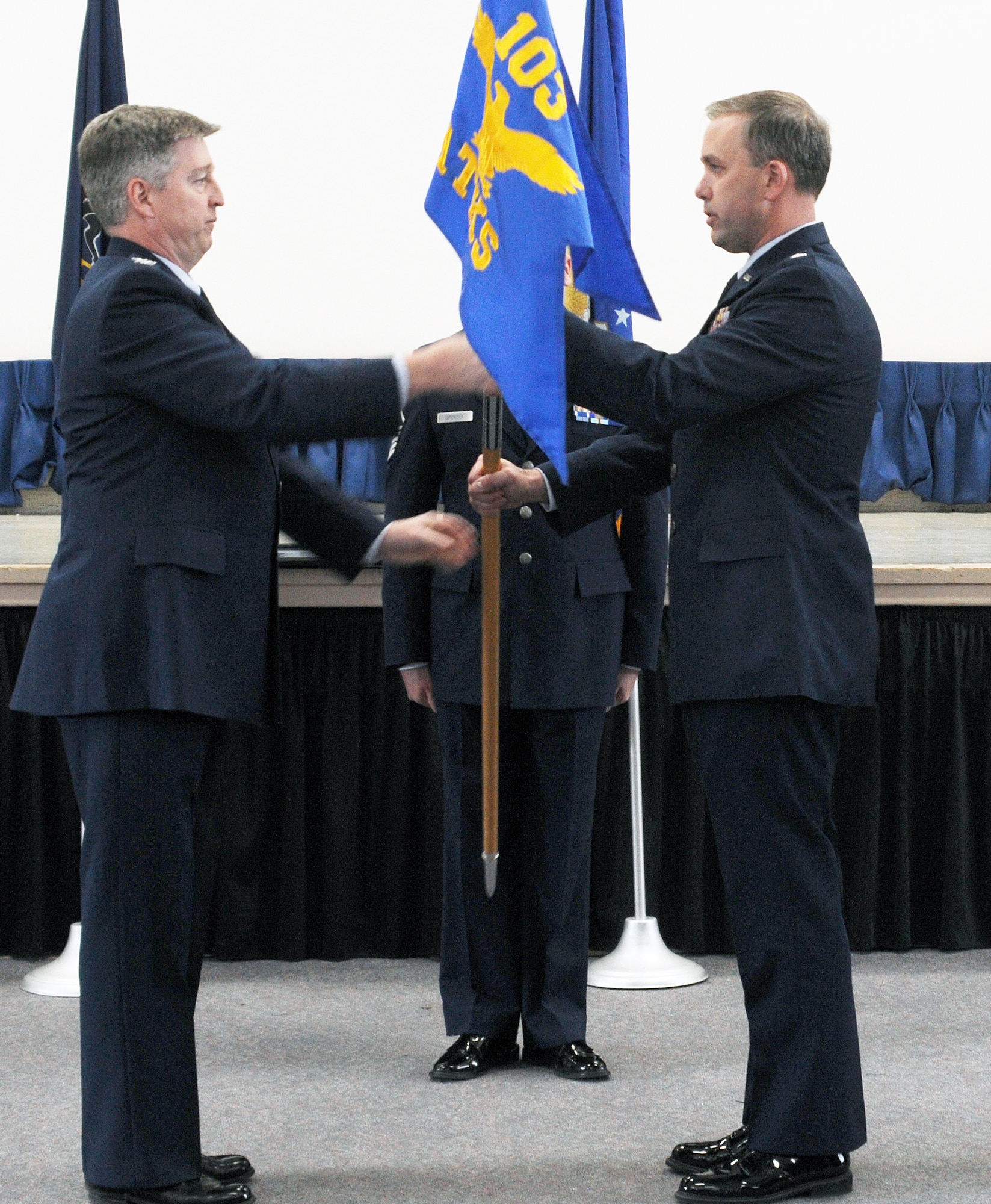 Col. John O’Brien, 111th Attack Wing Operations Group commander, hands off the guidon to Lt. Col. Peter as he assumes command of the 103rd Attack Squadron, Horsham Air Guard Station, Pa. March 10, 2018. Peter stated he intends to continue forward on the current mission path, while extending on the great work of his predecessor.