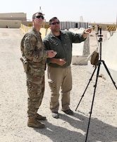 Staff Sgt. Warren Palmer, master trainer and senior intelligence advisor, Delta Company, 5th Battalion, 1st Security Forces Assistance Brigade, left, and Mike Podplesky, ARCENT Readiness Training Center - Kuwait (ARTC-KU) team lead, control the movements of a PD-100 Black Hornet Nano Drone as it flies, Mar. 6, 2018. The Black Hornet weighs 18 grams and has a vertical ceiling of almost two miles.