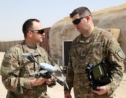 Sgt. Joseph Lindsey, signal systems repair specialist, left, and Sgt. 1st Class Derek Balboa, master trainer and team sergeant, both attached to the Alpha Company, 1st Battalion, 1st Security Forces Assistance Brigade, discuss their drone and its flying capabilities, Mar. 6, 2018. Both Soldiers, stationed out of Fort Benning, Ga., are taking part in Small Unmanned Arial System (SUAS) and Counter Small Unmanned Arial System (CUAS) training before proceeding to their final destination in Afghanistan.