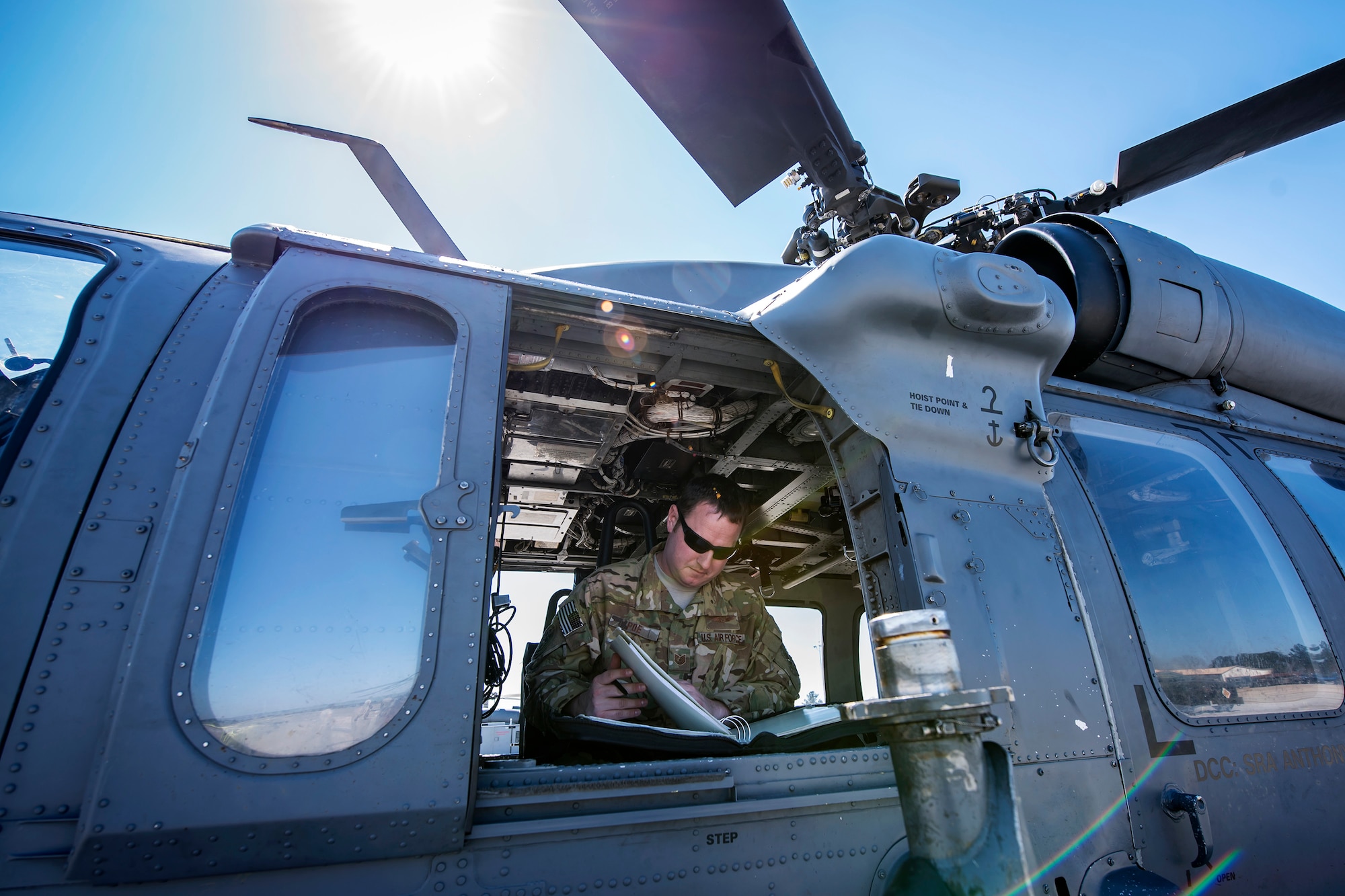 Tech. Sgt. Joshua Poe, 41st Rescue Squadron (RQS) special missions aviator, reads a flight plan, March 15, 2018, at Moody Air Force Base, Ga. Airmen from the 41st RQS and 723d Aircraft Maintenance Squadron conducted pre-flight checks to ensure that an HH-60G Pave Hawk was fully prepared for a simulated combat search and rescue mission. (U.S. Air Force photo by Airman Eugene Oliver)