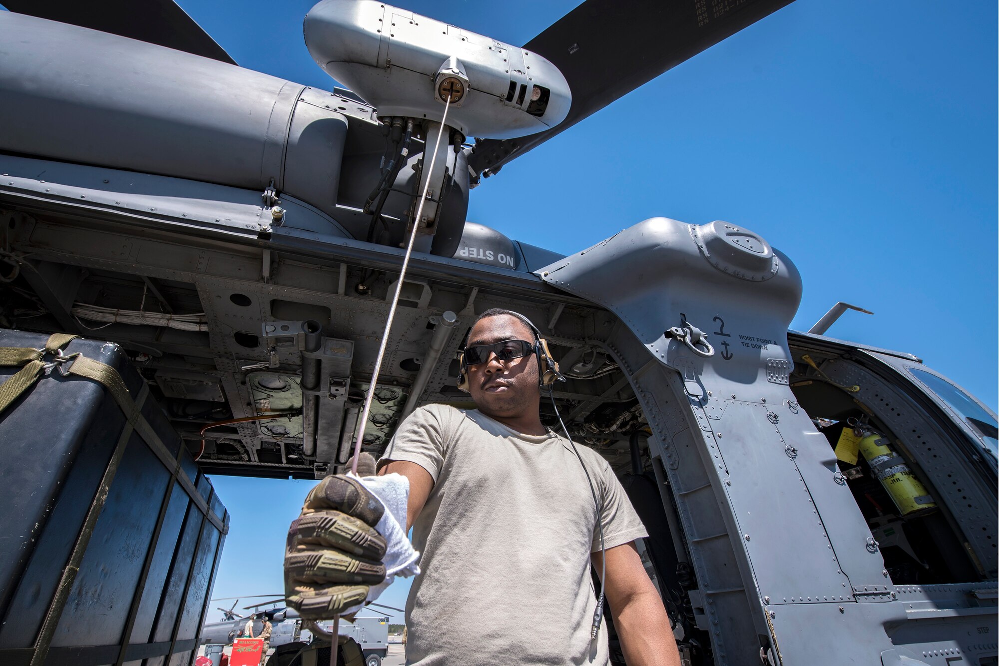 Senior Airman Latrell Solomon, 41st Rescue Squadron (RQS) special missions aviator, wipes the rappel wire of an HH-60G Pave Hawk, March 15, 2018, at Moody Air Force Base, Ga. Airmen from the 41st RQS and 723d Aircraft Maintenance Squadron conducted pre-flight checks to ensure that an HH-60G Pave Hawk was fully prepared for a simulated combat search and rescue mission. (U.S. Air Force photo by Airman Eugene Oliver)