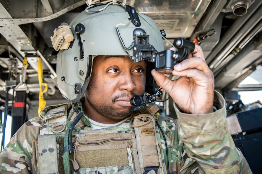 Senior Airman Latrell Solomon, 41st Rescue Squadron (RQS) special missions aviator, inspects his personal helmet camera, March 15, 2018, at Moody Air Force, Ga. Airmen from the 41st RQS and 723d Aircraft Maintenance Squadron conducted pre-flight checks to ensure that an HH-60G Pave Hawk was fully prepared for a simulated combat search and rescue mission. (U.S. Air Force photo by Airman Eugene Oliver)