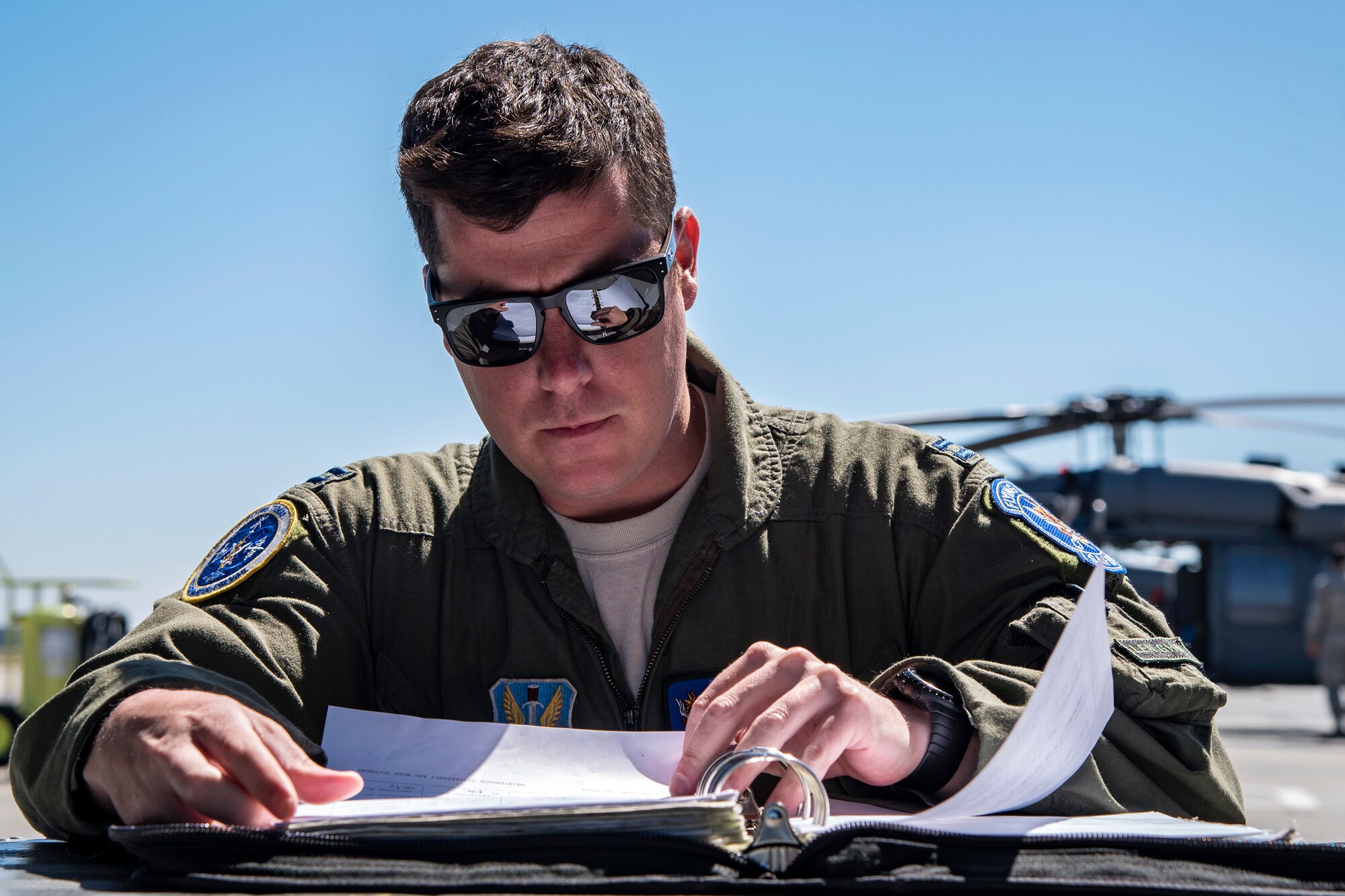 A pilot from the 41st Rescue Squadron (RQS) reads a flight plan, March 15, 2018, at Moody Air Force Base, Ga. Airmen from the 41st RQS and 723d Aircraft Maintenance Squadron conducted pre-flight checks to ensure that an HH-60G Pave Hawk was fully prepared for a simulated combat search and rescue mission. (U.S. Air Force photo by Airman Eugene Oliver)
