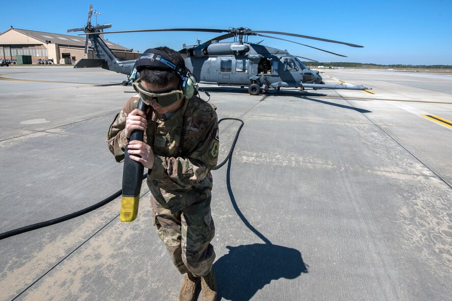 Airman First Class Ryan Lenig, 723d Aircraft Maintenance Squadron (AMXS) crew chief, pulls a power cable away from an HH-60G Pave Hawk, March 15, 2018, at Moody Air Force Base, Ga. Airmen from the 41st Rescue Squadron and the 723d AMXS conducted pre-flight checks to ensure that an HH-60G Pave Hawk was fully prepared for a simulated combat search and rescue mission. (U.S. Air Force photo by Airman Eugene Oliver)