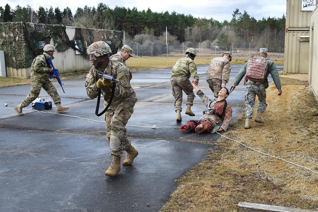 Soldiers evacuate a simulated casualty.