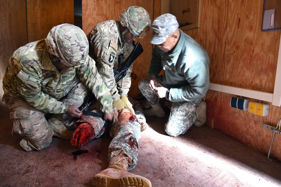 Soldiers apply medical aid to a simulated casualty.