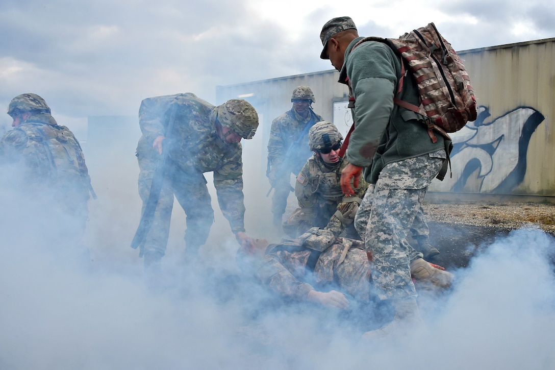 Soldiers evacuate a simulated casualty.
