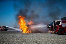 Aircraft rescue firefighting vehicles from the 23d Civil Engineer Squadron (CES) extinguish an aircraft simulator fire during a live-fire burn exercise, March 15, 2018, at Moody Air Force Base, Ga. Firefighters from the 23d CES conducted the exercise to demonstrate aircraft rescue firefighting capabilities to community leaders and Moody’s honorary commanders. (U.S. Air Force photo by Airman 1st Class Erick Requadt)