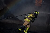 A firefighter from the 23d Civil Engineer Squadron (CES) carries a fire hose during a live-fire burn exercise, March 15, 2018, at Moody Air Force Base, Ga. Firefighters from the 23d CES conducted the exercise to demonstrate aircraft rescue firefighting capabilities to community leaders and Moody’s honorary commanders. (U.S. Air Force photo by Airman 1st Class Erick Requadt)