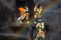 Firefighters from the 23d Civil Engineer Squadron (CES) work together to extinguish a fire on an aircraft simulator during a live-fire burn exercise, March 15, 2018, at Moody Air Force Base, Ga. Firefighters from the 23d CES conducted the exercise to demonstrate aircraft rescue firefighting capabilities to community leaders and Moody’s honorary commanders. (U.S. Air Force photo by Airman 1st Class Erick Requadt)
