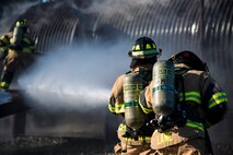 Senior Airman Justin Lane, right, and Staff Sgt. Tyler McFarland, 23d Civil Engineer Squadron (CES) firefighters, work together to extinguish a fire on an aircraft simulator during a live-fire burn exercise, March 15, 2018, at Moody Air Force Base, Ga. Firefighters from the 23d CES conducted the exercise to demonstrate aircraft rescue firefighting capabilities to community leaders and Moody’s honorary commanders. (U.S. Air Force photo by Airman 1st Class Erick Requadt)