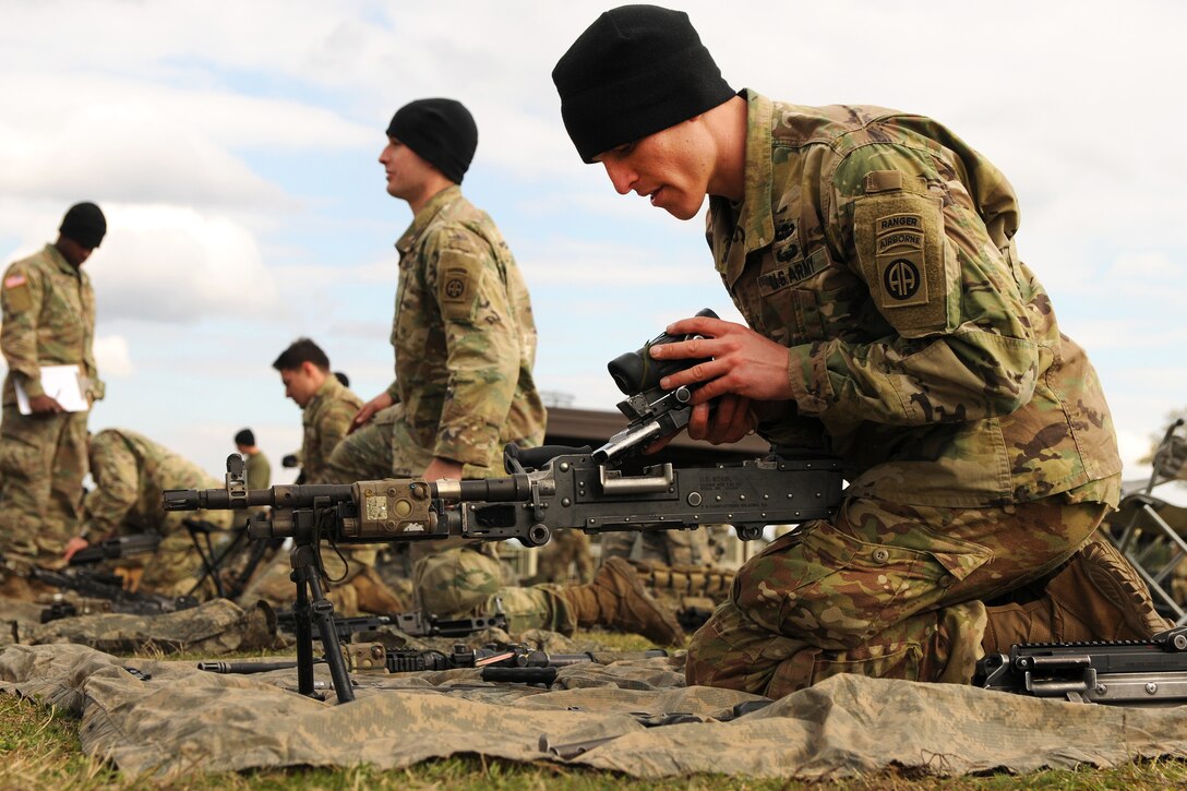 Soldiers disassemble, assemble a variety of weapons.
