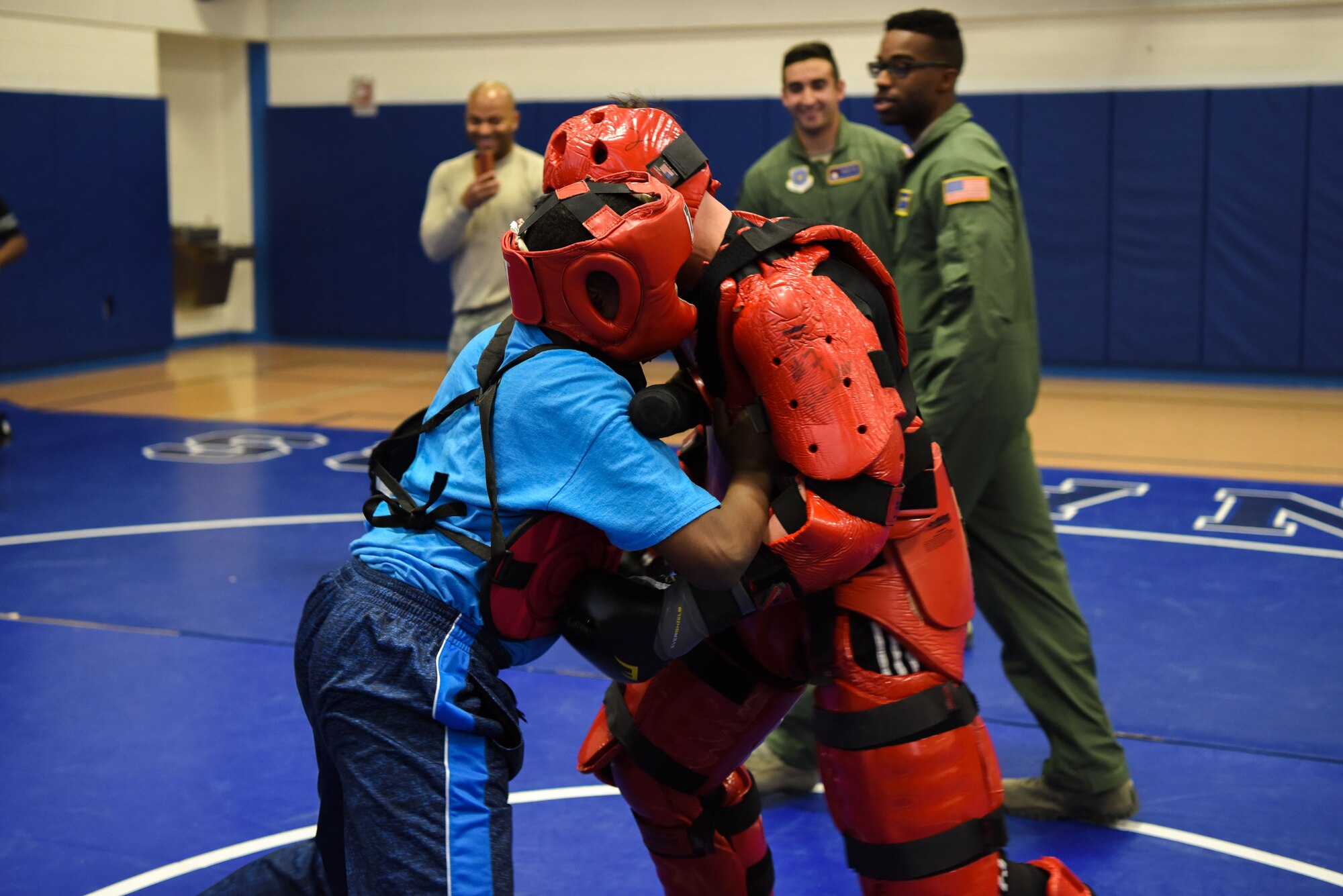Staff Sgt. Michael Rice, 436th Security Forces Squadron raven, and a Central Middle School student partake in baton training during a demonstration by the Ravens March 8, 2018, at Central Middle School in Dover, Del. The students were given an opportunity to go against the “Red Man” after being shown some of the baton strikes the Ravens use. (U.S. Air Force Photo by Airman 1st Class Zoe M. Wockenfuss)
