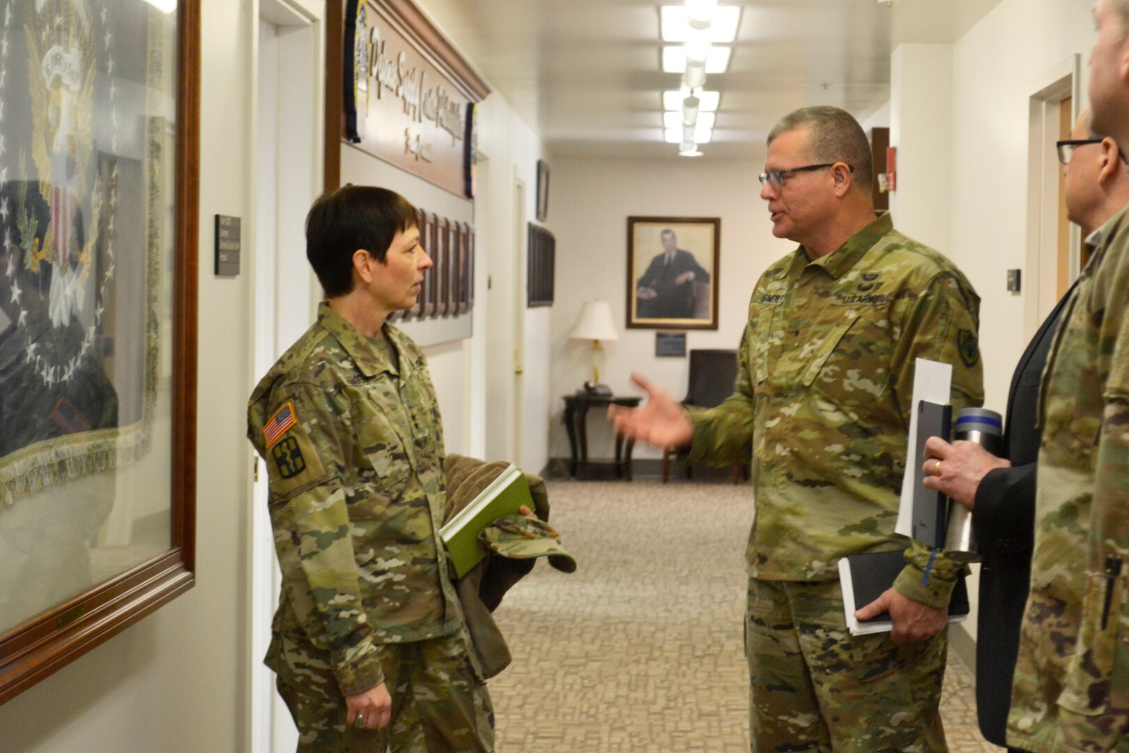 Army Maj. Gen. Barbara Holcomb, U.S. Army Medical Research and Material Command commanding general, left, speaks with Brig. Gen. Mark Simerly, DLA Troop Support commander, right, at DLA Troop Support, March 16, 2018, in Philadelphia.