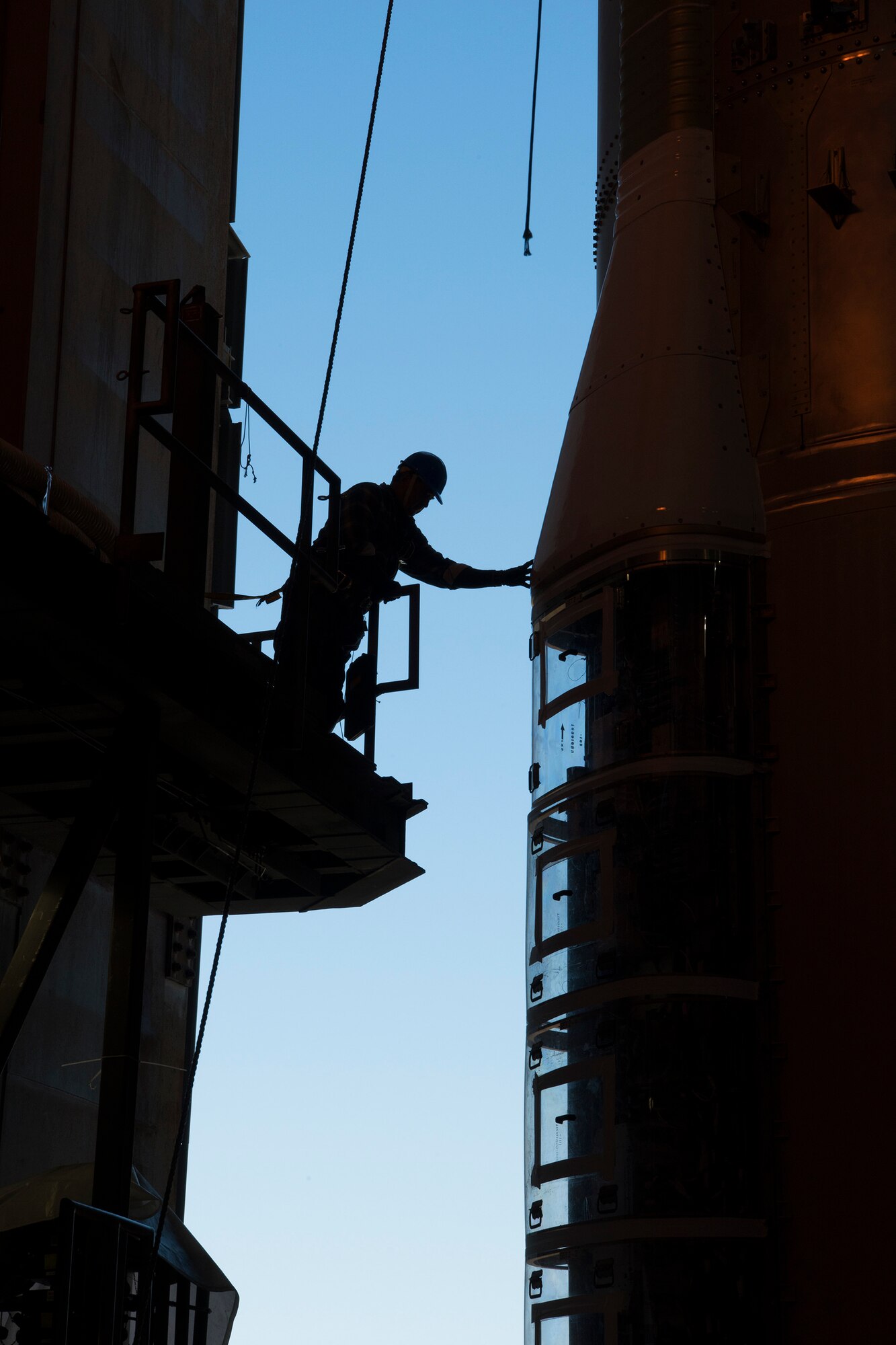 A United Launch Alliance employee helps secure a booster for an Atlas V rocket at the ULA Vertical Integration Facility, located on Cape Canaveral Air Force Station, Fla., March 13. The booster, which weighs more than 45,000-pounds, was hoisted into the facility by a team of ULA and 5th Space Launch Squadron engineers. (U.S. Air Force photo by Airman Dalton Williams)