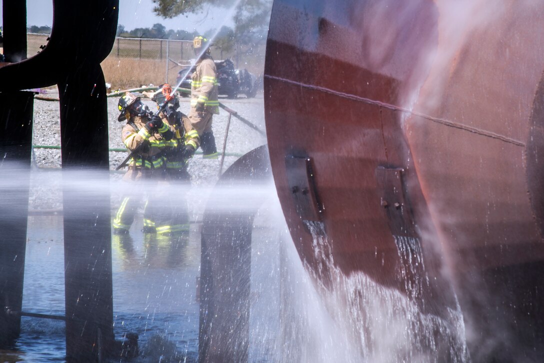 Firefighters from the 23d Civil Engineer Squadron (CES), extinguish a fire during a live-fire burn exercise, March 16, 2018, at Moody Air Force Base, Ga. Firefighters from the 23d CES conducted the exercise to demonstrate their firefighting capabilities to community leaders and Moody’s honorary commanders. (U.S. Air Force photo by Airman Eugene Oliver)