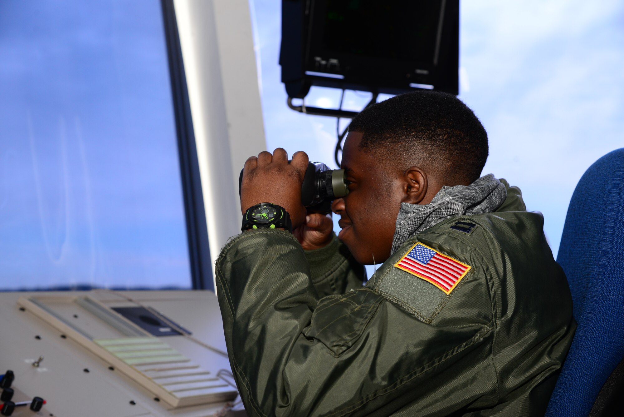 Kareem Bennett “glasses” the horizon March 16, 2018, from the 436th Operations Support Squadron air traffic control tower on Dover Air Force Base, Del. Bennett spent the day touring the installation with members of the 3rd Airlift Squadron as an honorary pilot for the day. (U.S. Air Force photo by Staff Sgt. Aaron J. Jenne)