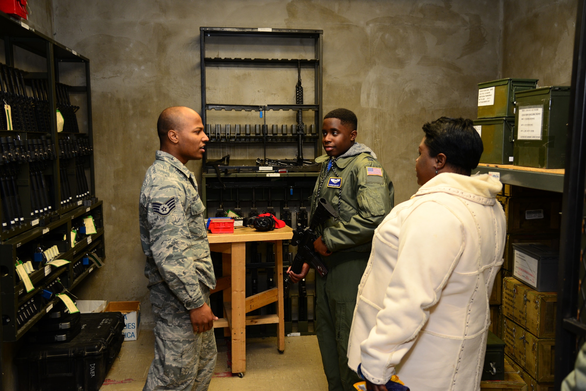 Staff Sgt. Jose Lopez Rodriguez, 436th Security Forces Squadron combat arms instructor, discusses various weapons platforms with Kareem Bennett, 3rd Airlift Squadron honorary pilot for a day, and Aniszia Liverpool, Bennett’s mother, during a private tour of the installation March 16, 2018, at Dover Air Force Base, Del. Bennett, a patient at Alfred I. duPont Hospital for Children in Wilmington, Del., became an honorary pilot and learned more about various Air Force careers, and how they contribute to the mobility mission. (U.S. Air Force photo by Staff Sgt. Aaron J. Jenne)