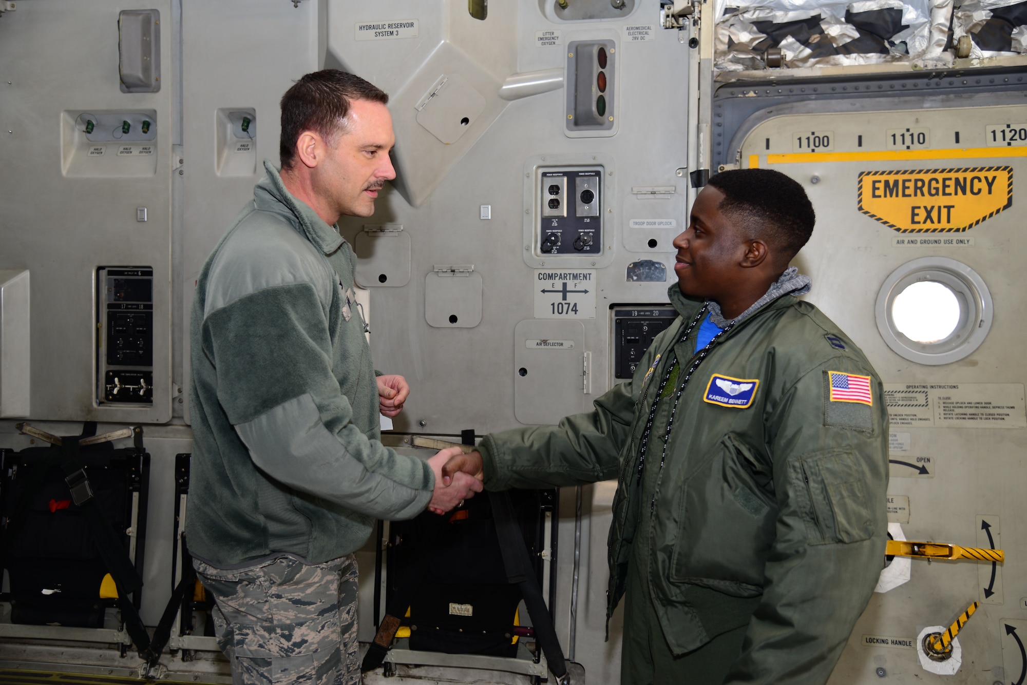 Col. Ethan Griffin, 436th Airlift Wing commander, presents a coin to Kareem Bennett during the 3rd Airlift Squadron Pilot for a Day event March 16, 2018, at Dover Air Force Base, Del. Bennett visited multiple base shops during his tour, including the 436th Operations Support Squadron’s aircrew flight equipment shop, the air traffic control tower, radar approach control, the 436th Security Forces Squadron’s combat arms training facilities and the military working dog kennels. (U.S. Air Force photo by Staff Sgt. Aaron J. Jenne)