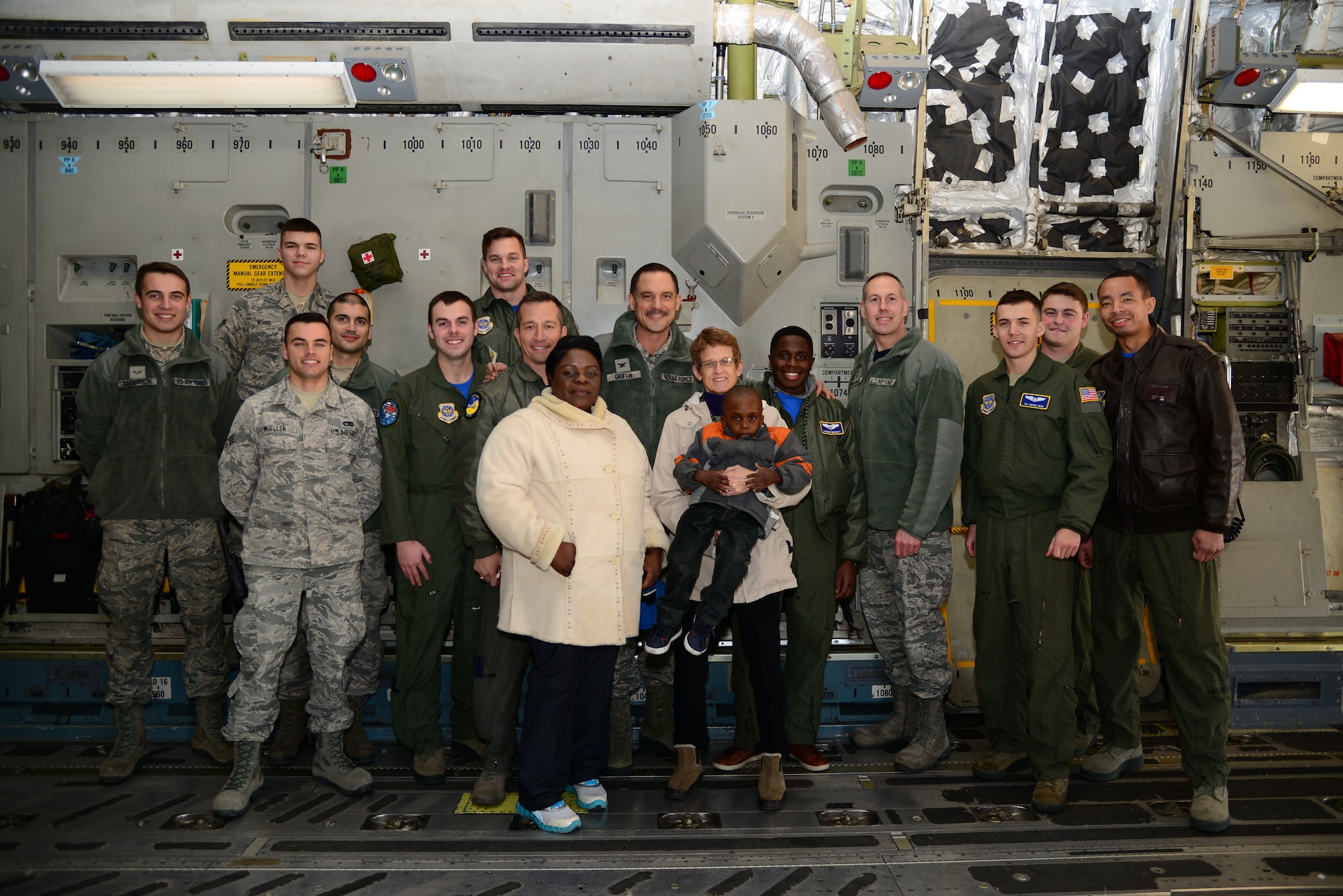 A group of members assigned to Dover Air Force Base, Del., and Holloman AFB, N.M., stand with Kareem Bennett (center) and his family on the deck of a C-17 Globemaster III March 16, 2018, at Dover AFB. Bennett was invited by the 3rd Airlift Squadron to participate in their honorary Pilot for a Day program, where he saw a behind-the-scenes view of the day-to-day mission of the Airmen of various military careers. (U.S. Air Force photo by Staff Sgt. Aaron J. Jenne)