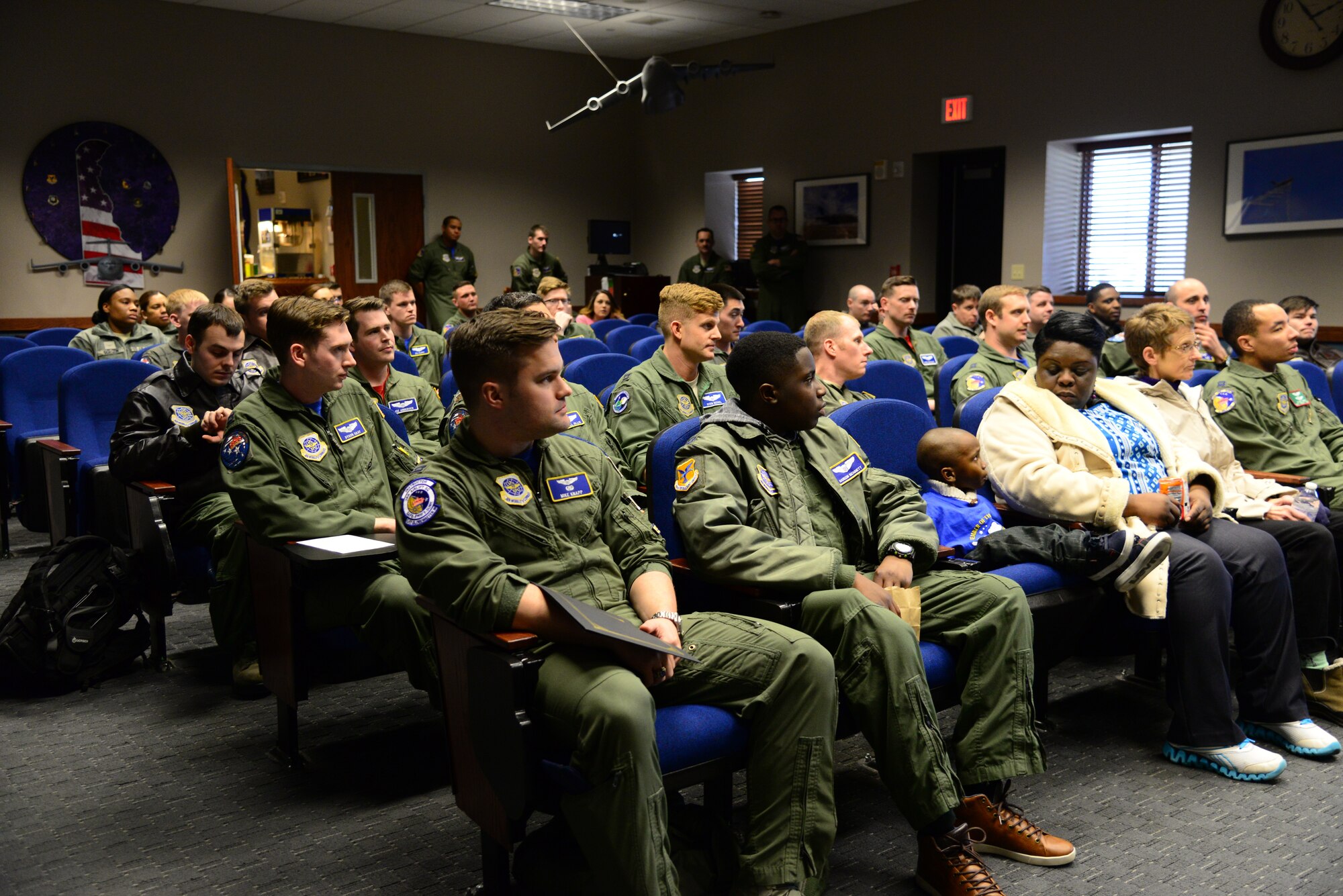 From left, Capt. Michael Knapp, 3rd Airlift Squadron chief of standards and evaluation and one of the Pilot for a Day program leads, Kareem Bennett and his family participate in a 3rd AS roll call March 16, 2018, at Dover Air Force Base, Del. Bennett and his family were invited by the 3rd AS to participate in their honorary Pilot for a Day program. (U.S. Air Force photo by Staff Sgt. Aaron J. Jenne)