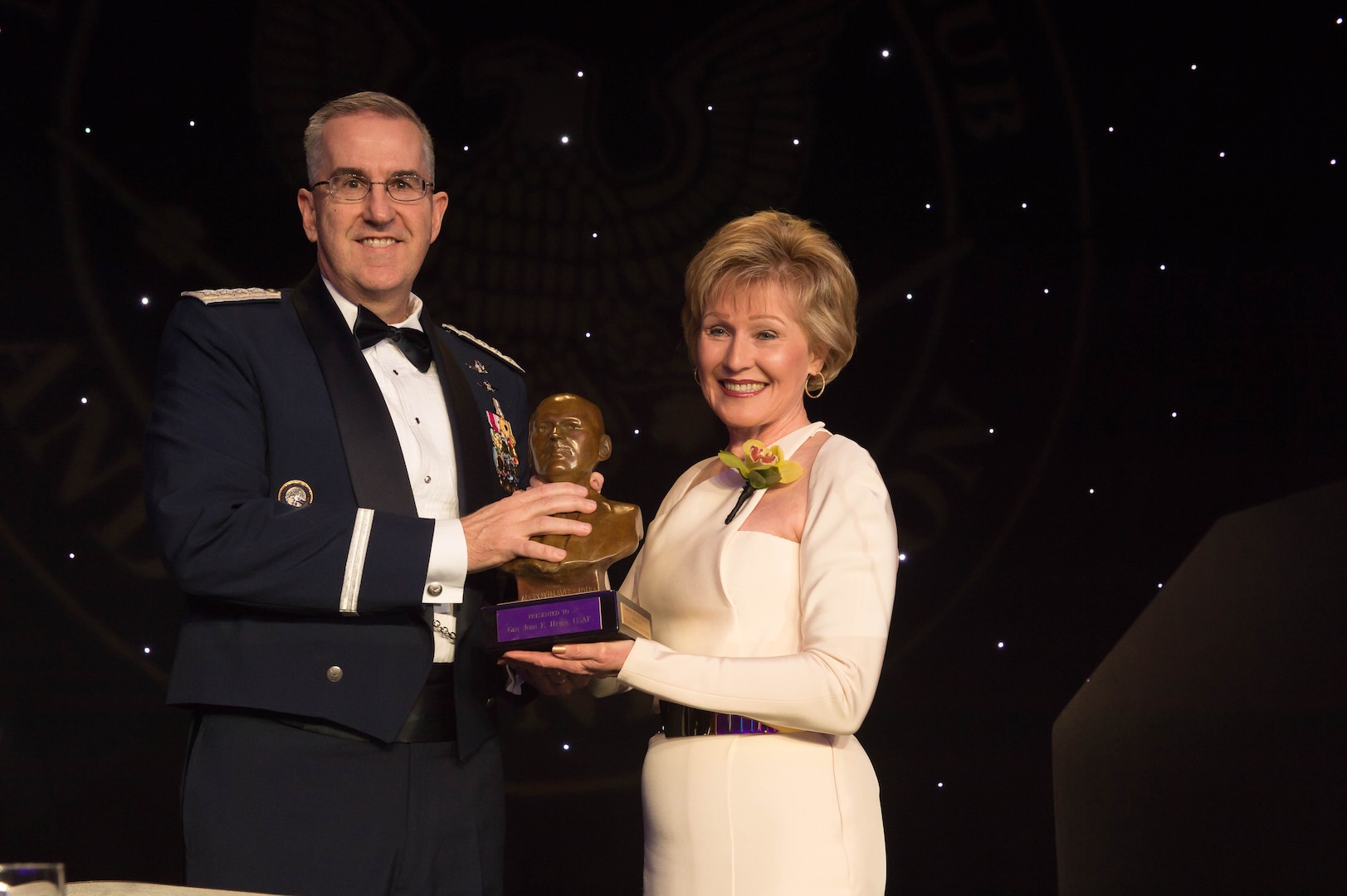 National Space Club & Foundation Board of Director President Sandy Coleman presents U.S. Air Force Gen. John Hyten the Dr. Robert H. Goddard Memorial Trophy at the 61st Annual Robert H. Goddard Memorial Dinner in Washington, D.C., March 16, 2018. Hyten was honored for his distinguished military career and his ongoing efforts dedicated to the National Security Space Enterprise.