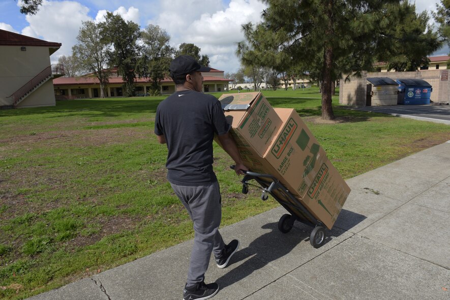 Tech. Sgt. Tony Jones, 60th Comptroller Squadron, uses a dolly to transport several boxes of jackets to the entrance of the Airmen’s Attic at Travis Air Force Base, Calif., March 17, 2018. The jackets were donated by Marina Cassimus of San Rafael, Calif., a widow of an Air Force veteran, along with books and several other items. Jones volunteered to make the 94-mile trip to San Rafael and back to Travis to deliver the jackets. (U.S. Air Force photo/Tech. Sgt. James Hodgman)