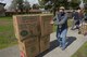Master Sgt. Philip Waite, 60th Aircraft Maintenance Squadron, pushes a dolly with two boxes of jackets toward the entrance of the Airmen’s Attic at Travis Air Force Base, Calif., March 17, 2018. The jackets were donated by Marina Cassimus of San Rafael, Calif., a widow of an Air Force veteran, along with books and other supplies. (U.S. Air Force photo/Tech. Sgt. James Hodgman)