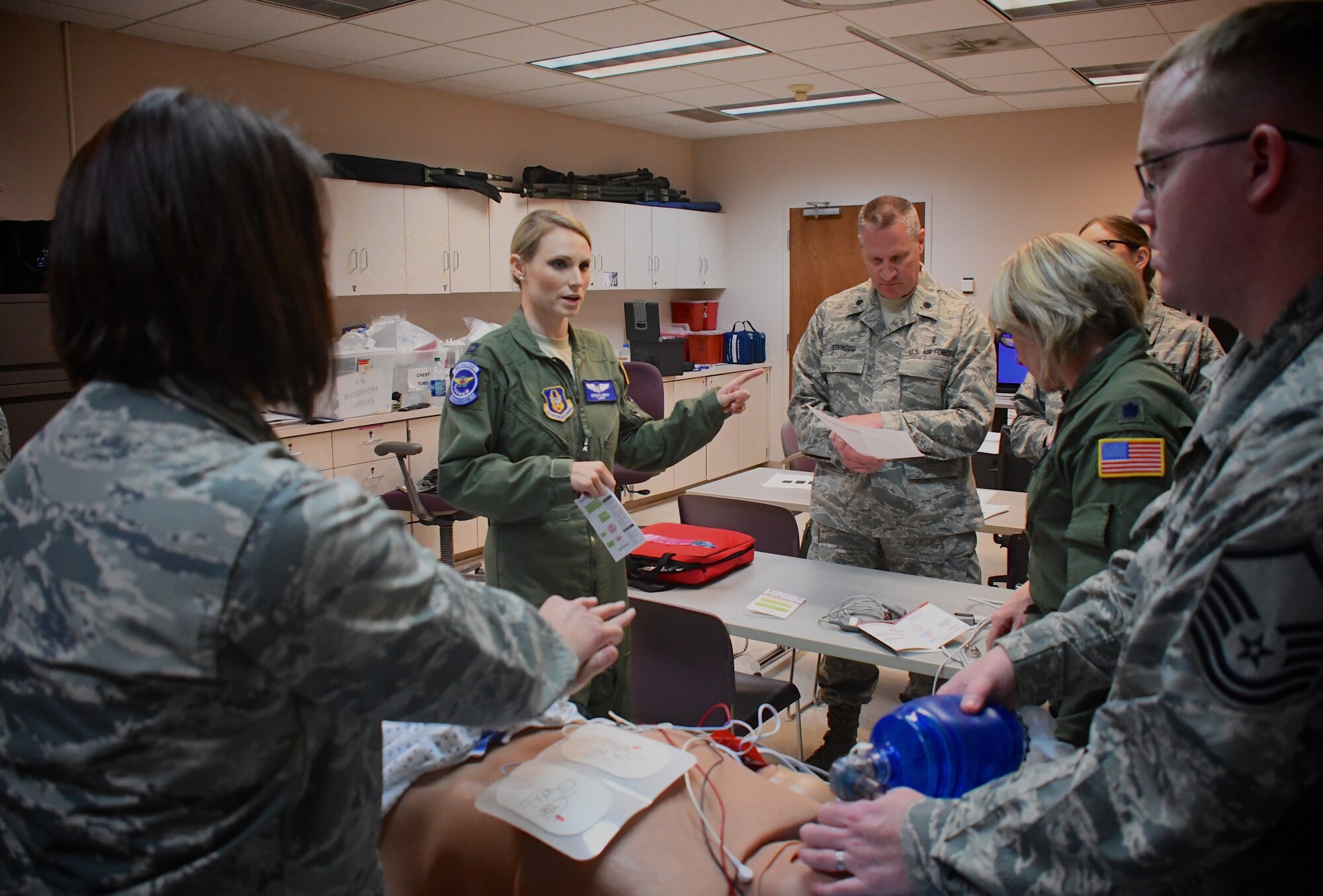 Capt. Jessica Emory, 932nd Aeromedical Evacuation Squadron, and Lt. Col. James Stenger of the 932nd Medical Squadron, give directions and discuss various medical procedures from their unique backgrounds in both military and community work. Members of the 932nd Airlift Wing participated in medical refresher courses March 4, 2018, at Scott Air Force Base, Ill. During this particular class, medical teams from the 932nd Medical Group and 932nd Aeromedical Evacuation Squadron worked in a training area using a simulated (robotic) patient to check vital signs electronically. The training emphasized the breadth of skills necessary to run through checklists, communicate to each person what their role is, and use teamwork to save lives.  (U.S. Air Force photo by Lt. Col. Stan Paregien)