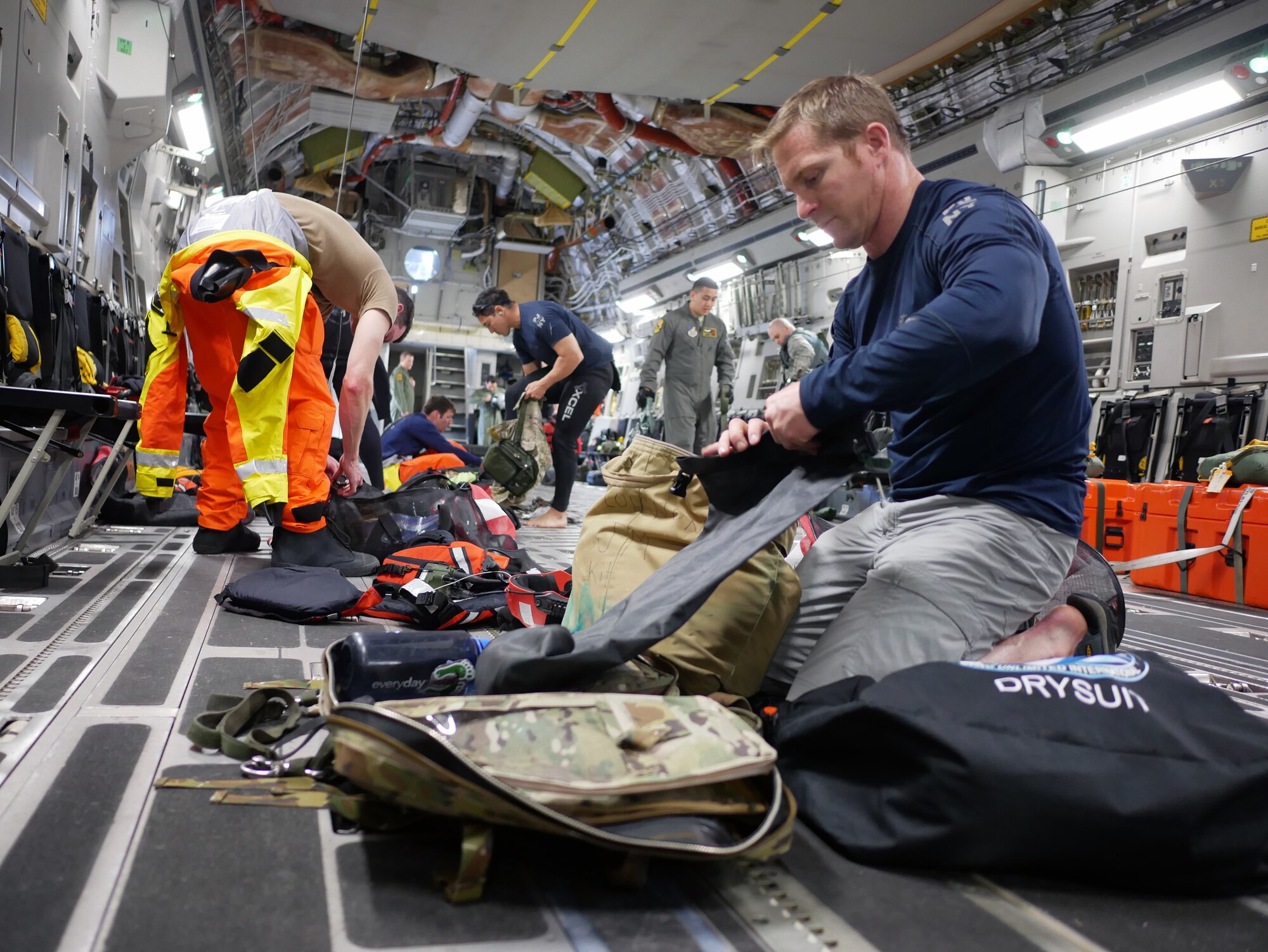 Tech. Sgt. Westley Loignon, 103rd Rescue Squadron pararescueman and jumpmaster, prepares his life support equipment aboard a C-17 Globmaster III from the 204th Airlift Squadron March 4, 2017, at Joint Base Pearl Harbor-Hickam, Hawaii.