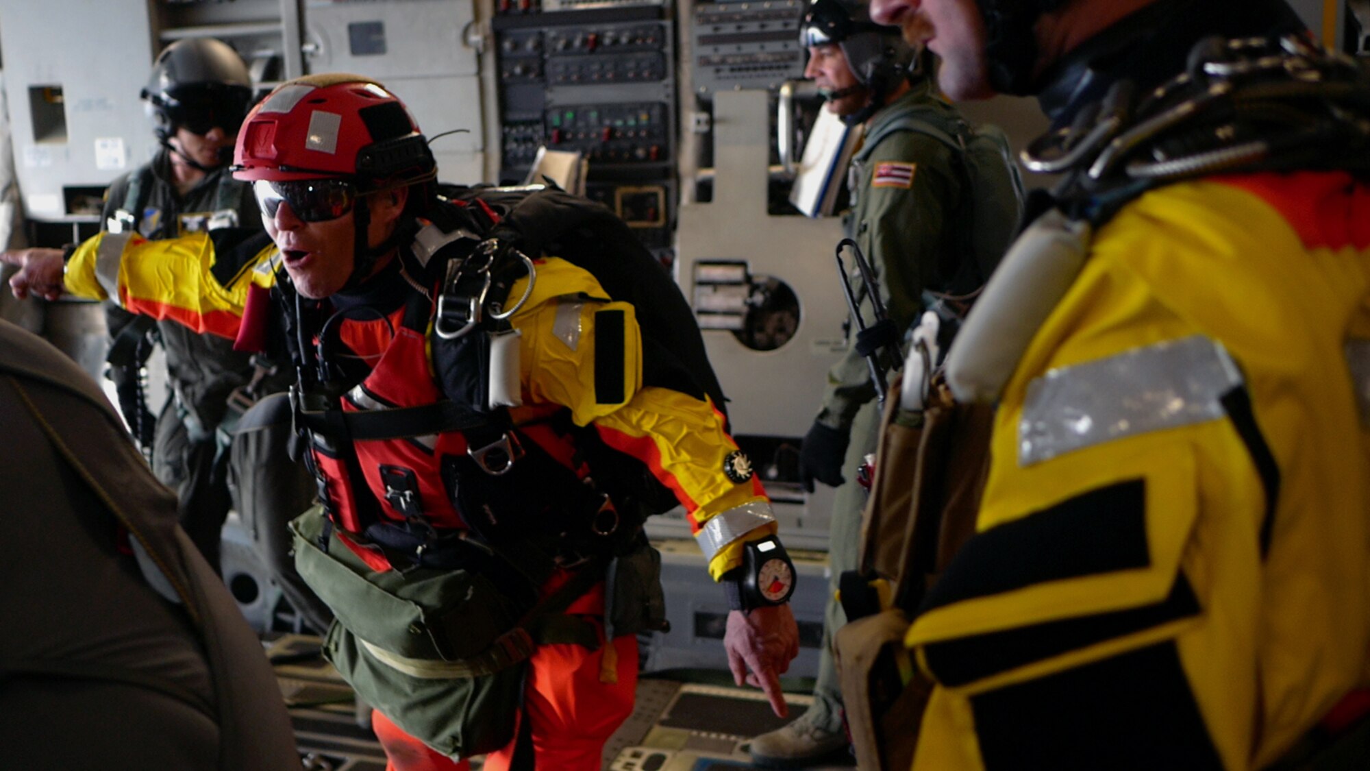 Tech. Sgt. Westley Loignon, 103rd Rescue Squadron pararescueman and jump master, instructs his team to jump off a C-17 Globmaster III March 4, 2017, off the coast of Oahu, Hawaii.