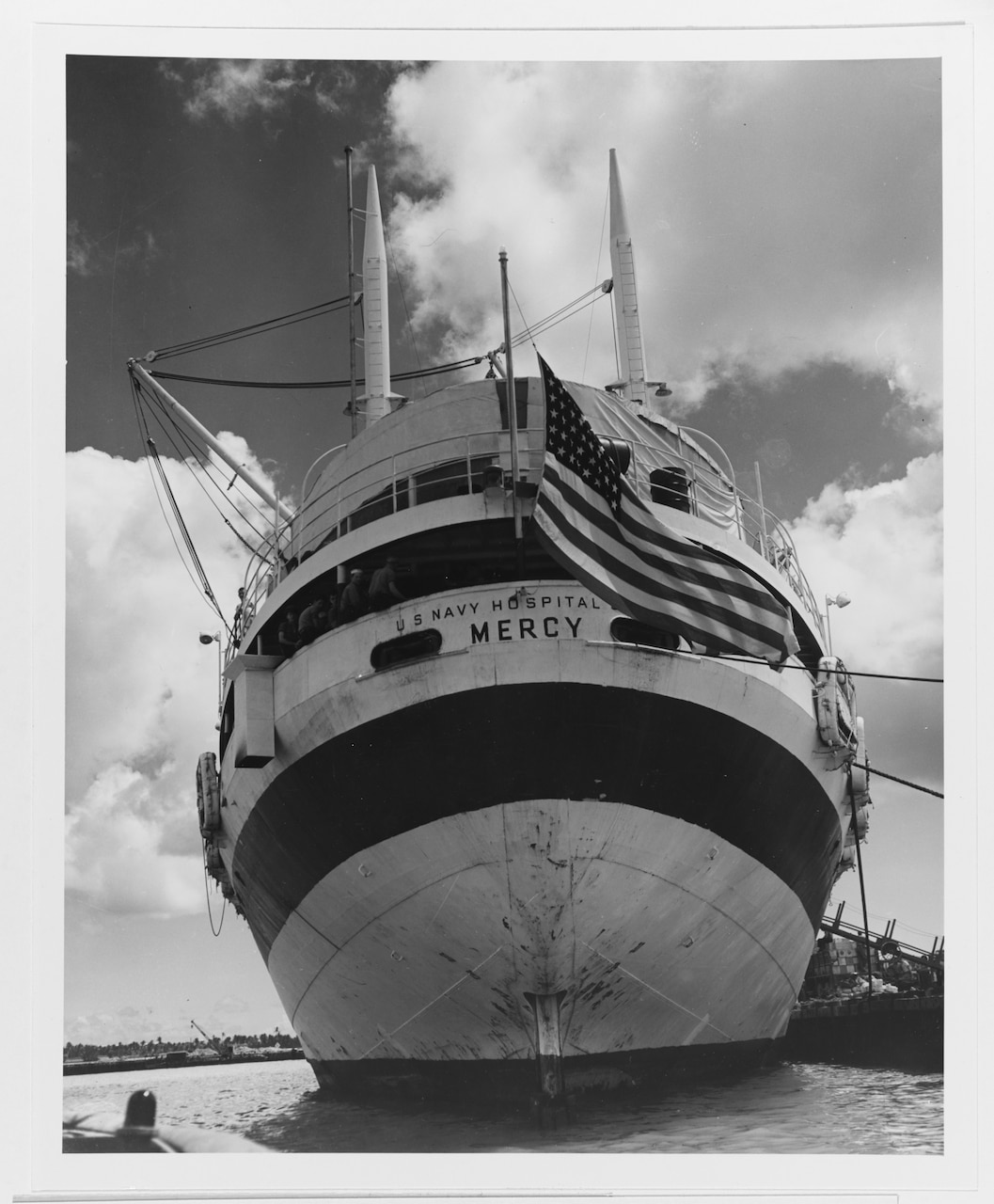 Archive photo showing USS Mercy (AH-8) docked at Guam on May 9, 1945, to discharge men wounded in the Okinawa area. Official U.S. Navy Photograph, now in the collections of the National Archives.