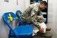 Tech. Sgt. Noe Rodrigues, 48th Equipment Maintenance Squadron Fabrication Flight NCO in charge of Corrosion Control, puts on protective a bodysuit while inside the new decontamination booth on RAF Lakenheath, England, Mar. 13, 2018. Rodriguez was able to develop a new decontamination process to better support requirements and the Airmen executing them by spearheading the construction of two decontamination booths. (U.S. Air Force photo/Airman 1st Class Christopher S. Sparks)