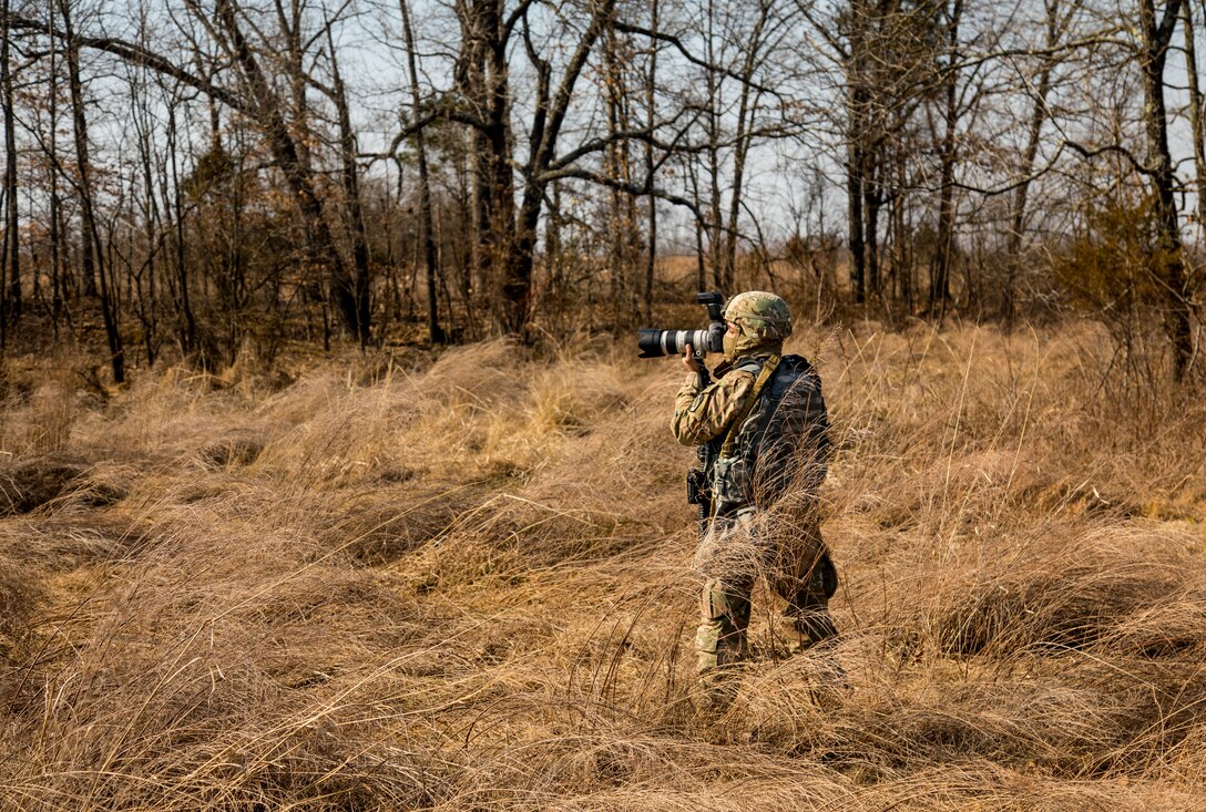 U.S. Army Reserve Spc. Torrance Saunders, a combat documentation/ production specialist with the 982nd Combat Camera Company (Airborne) maneuvers to photograph Soldiers during a react to contact battle drill during Combat Support Training Exercise (CSTX) at Fort Knox, Kentucky, March 15, 2018.