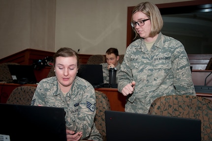Staff Sgt. Amanda Morgan, Cybersecurity Foundry Course student, receives assistance from Airman 1st Class Shelby McKinlay, a CFC instructor, at MacDill Air Force Base, Fla., March 9, 2018. Course instructors taught 100 cyberspace students various cybersecurity functions, processes, procedures and data analysis skills to further their ability to secure the Air Force Network. (U.S. Air Force photo by Senior Airman Mariette Adams)