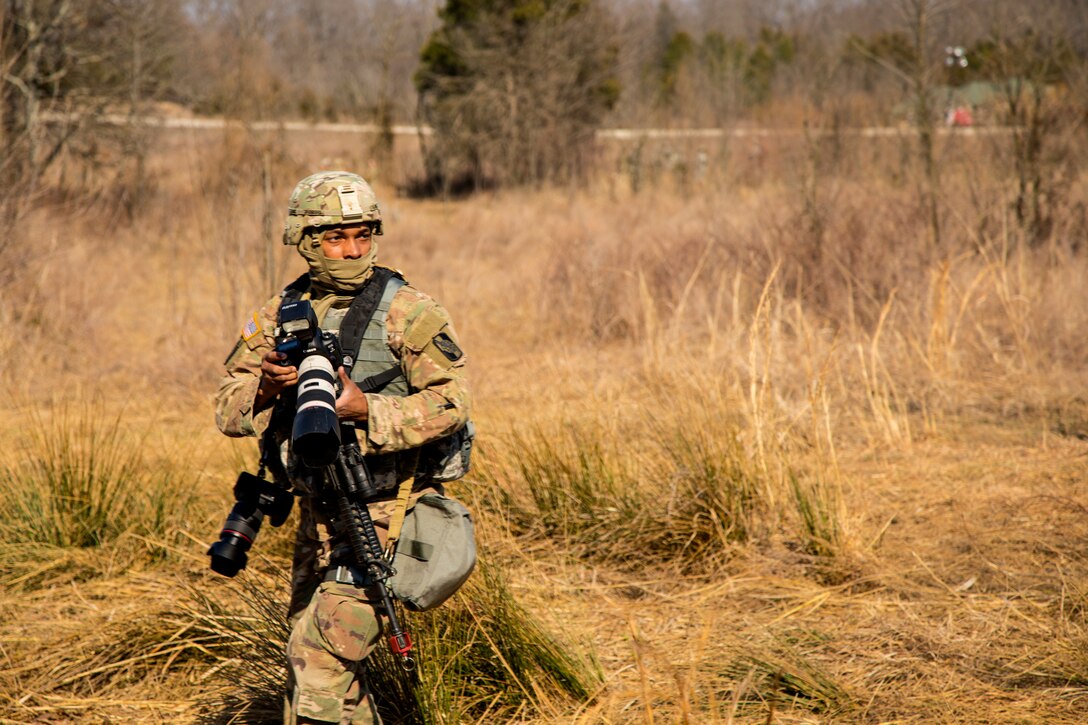 U.S. Army Reserve Spc. Torrance Saunders, a combat documentation/ production specialist with the 982nd Combat Camera Company (Airborne) maneuvers to photograph Soldiers during a react to contact battle drill during Combat Support Training Exercise (CSTX) at Fort Knox, Kentucky, March 15, 2018.