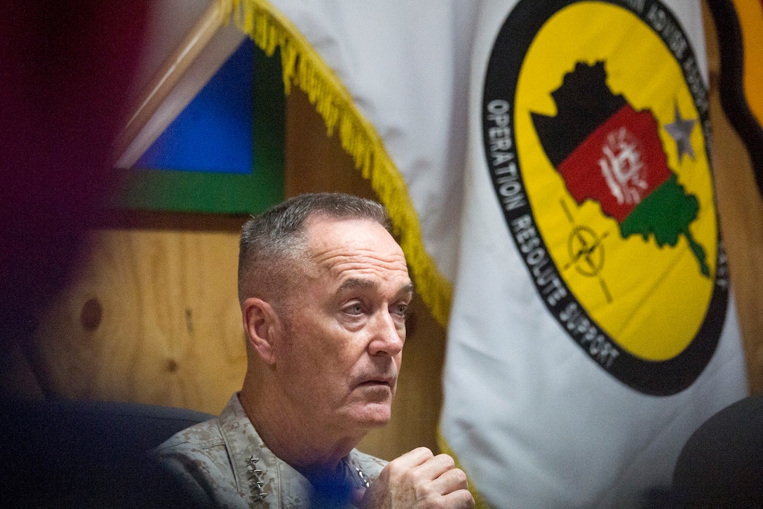 Marine Corps Gen. Joe Dunford, chairman of the Joint Chiefs of Staff, looks off to the right.