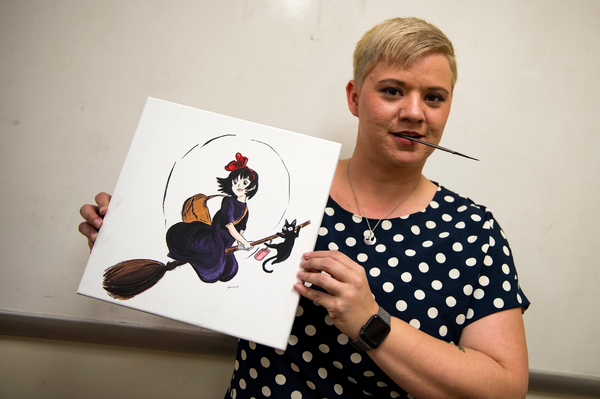 Dawn Harvey, artist, poses for a photo with her finished painting during Cub Con, a multi-genre entertainment convention, March 17, 2018, at Moody Air Force Base, Ga. The convention was held to spread awareness of the library’s new weekend hours as well as get people excited for Tiger Con, scheduled for April 14-15. (U.S. Air Force photo illustration by Airman 1st Class Erick Requadt)