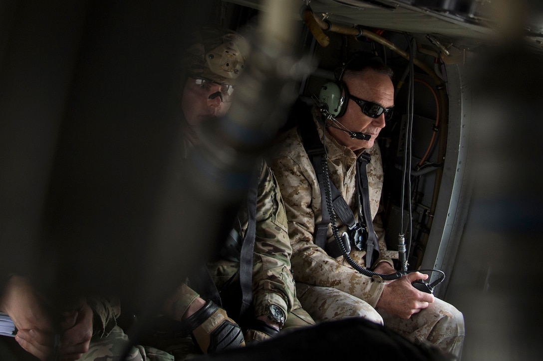 The chairman of the Joint Chiefs of Staff sits in a helicopter