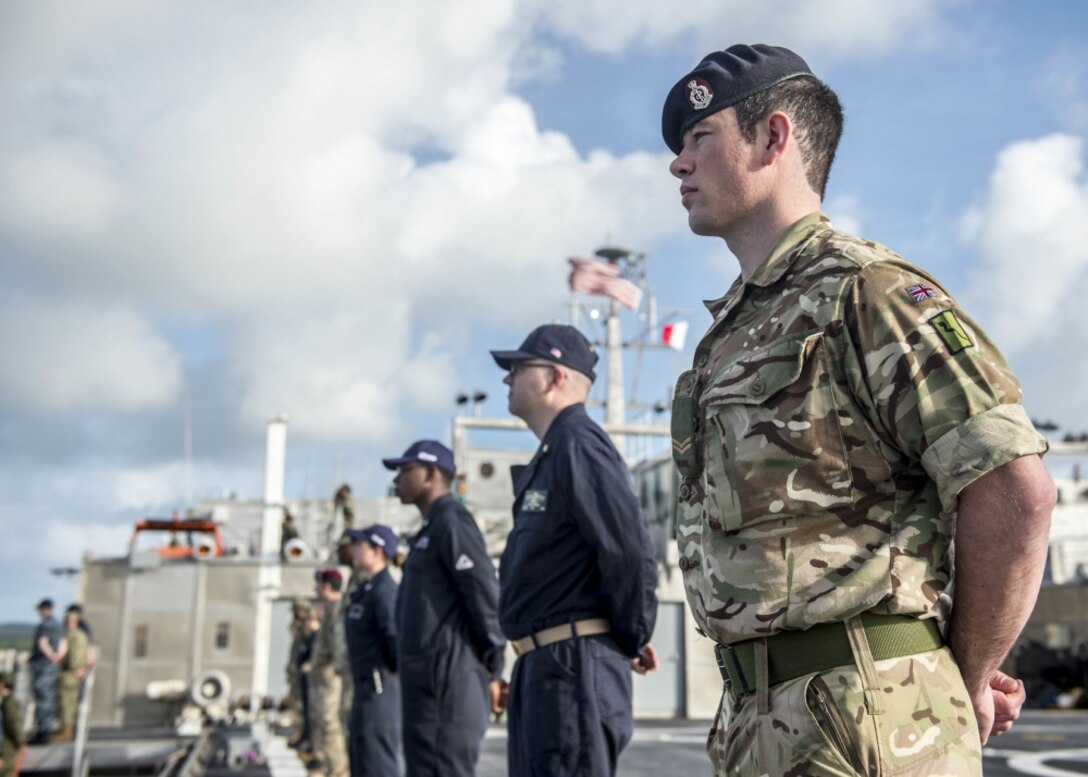 Combined forces aboard the expeditionary fast transport ship USNS Brunswick man the rails