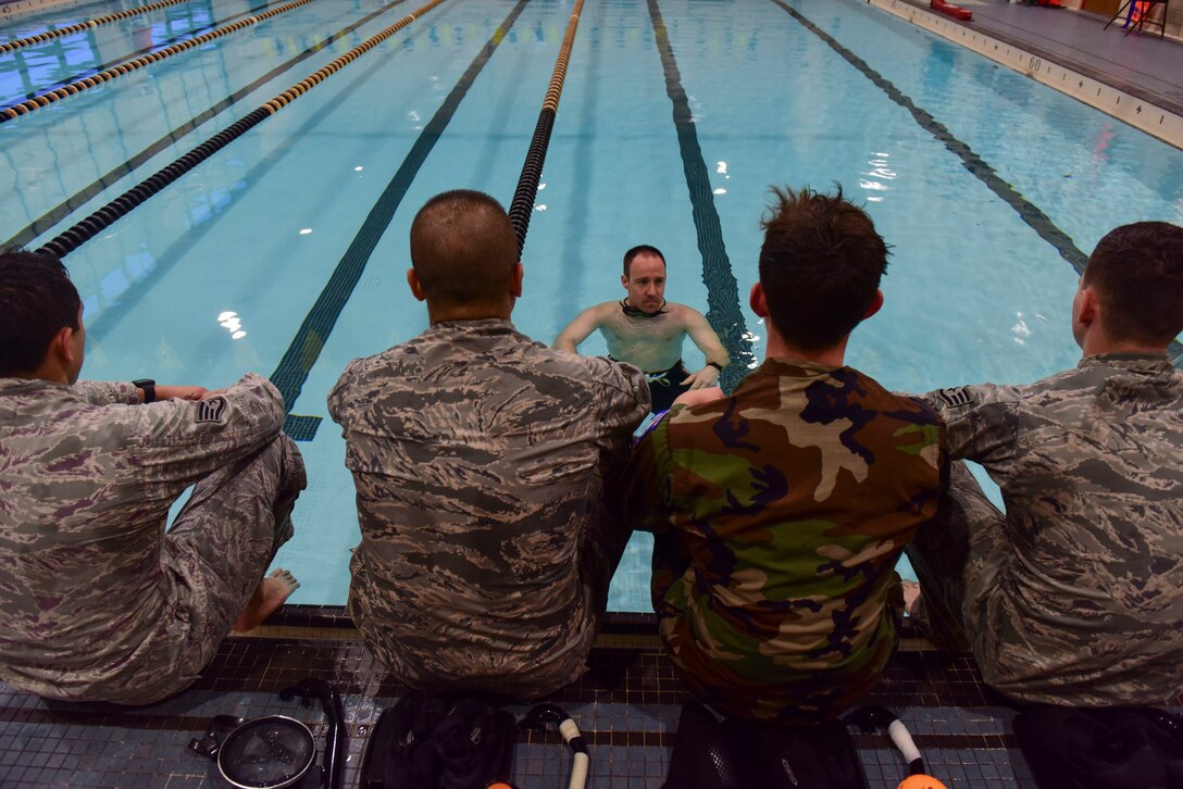 U.S. Air Force Senior Master Sgt. Travis Shaw, Headquarters Air Combat Command Surgeon General pararescue programs manager, talks to Airmen during a water confidence training class in Fort Eustis’ Anderson Field House at Joint Base Langley-Eustis, Virginia, March 6, 2018.