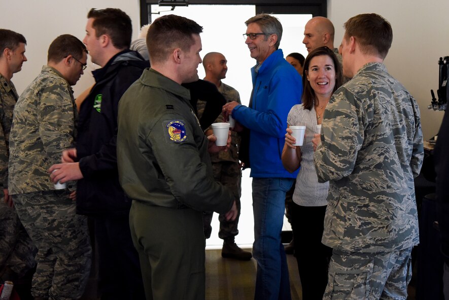 Team Dover’s commanders mingle with the base’s honorary commanders before their tour March 14, 2018, at Dover Air Force Base, Del. Together the Dover AFB commanders and their fellow community and political leaders exchange ideas, experiences and friendships. (U.S. Air Force photo by Airman 1st Class Zoe M. Wockenfuss)