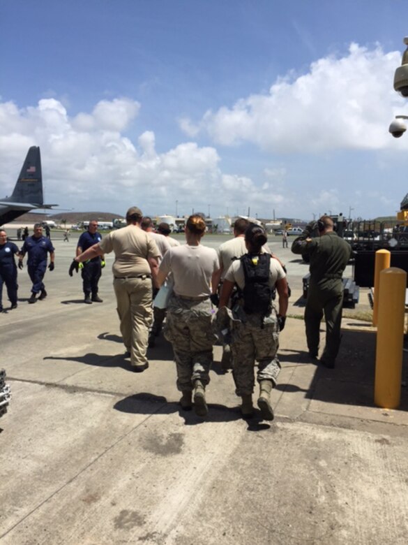 Members of a U.S. Air Force En Route Patient Staging System team from the 375th Medical Group based at Scott Air Force Base rush a patient to a waiting aircraft during Hurricane Maria relief efforts at Henry E. Rohlsen Airport, near Christiansted, St. Croix, U.S. Virgin Islands on Sept. 25, 2017. (Photo by Lt. Col. Elizabeth Anderson-Doze)