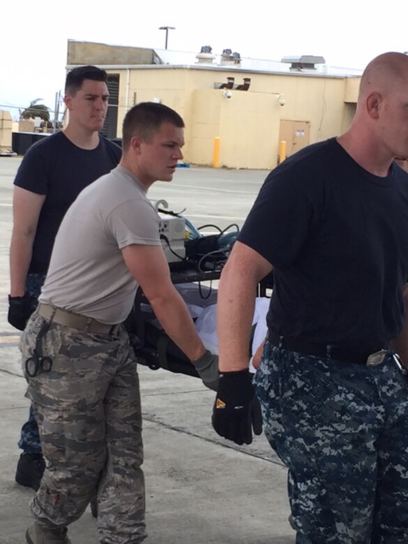 Members of the 375th Medical Groups and a U.S. Transportation Command manpower team, part of a U.S. Air Force En Route Patient Staging System team, transport a patient during Hurricane Maria relief efforts to a waiting aircraft after arriving at Henry E. Rohlsen Airport, near Christiansted in St. Croix, U.S. Virgin Islands on Sept. 23, 2017. On the first day, patients were carried nearly a quarter mile from the staging location to awaiting aircraft. Following Trusted Care huddles, where process improvements were discussed, teams obtained rickshaws to provide more efficient transport and reduce the risk of injury to patients and staff. (Photo by Lt. Col. Elizabeth Anderson-Doze)